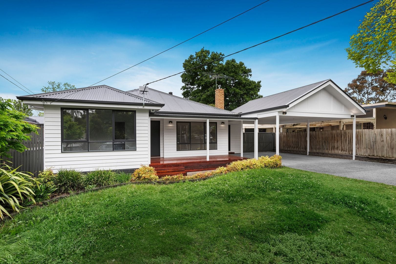 Front view of a renovated single-story house in Nunawading with a carport and landscaped garden.