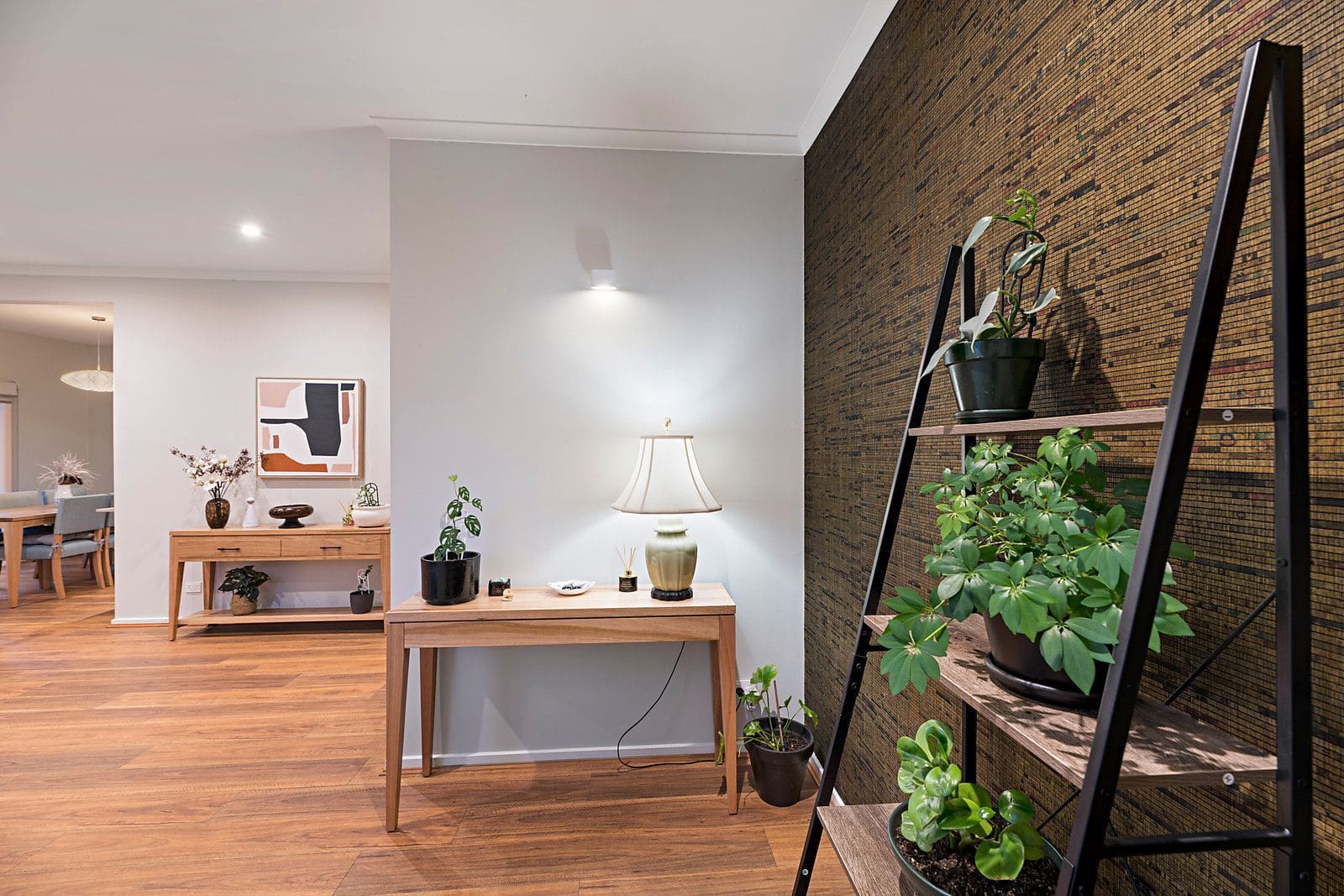 Renovated interior space with wooden furniture, potted plants, and modern decor.
