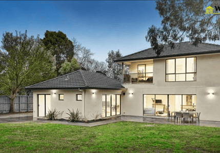 Modern two-storey home extension with large windows and an outdoor entertaining area.