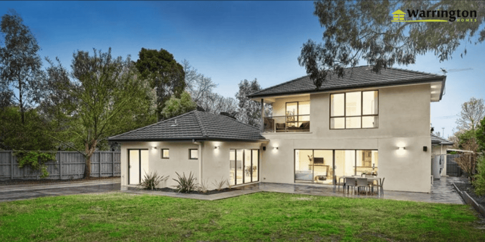 Modern two-storey home extension with large windows and an outdoor entertaining area.
